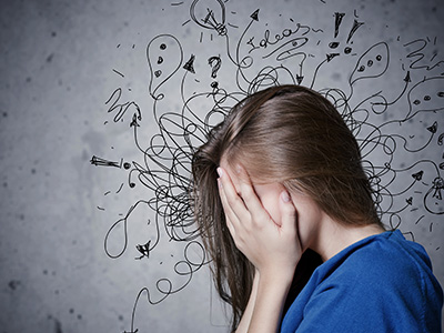 A young woman with her hand covering her face, surrounded by abstract doodles that seem to be emanating from her head.