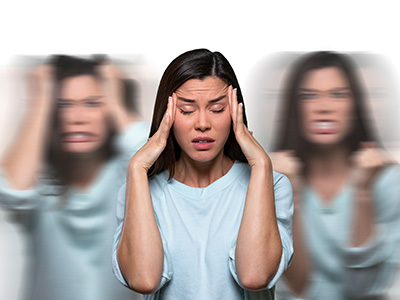 Woman with her hands on her head, appearing stressed or overwhelmed, surrounded by multiple blurred images of herself in various states of distress.