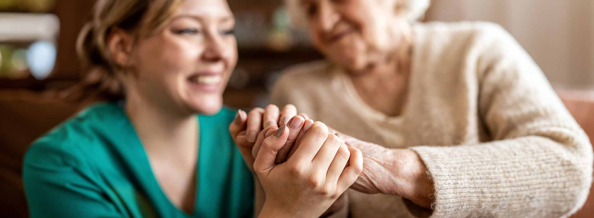 Two people holding hands in a warm embrace.